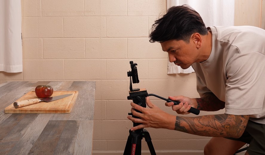 Close-up view of a person setting up a mobile phone video rig