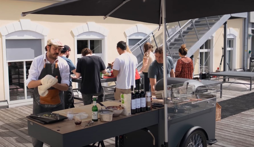 Outdoor cooking station bustling with activity