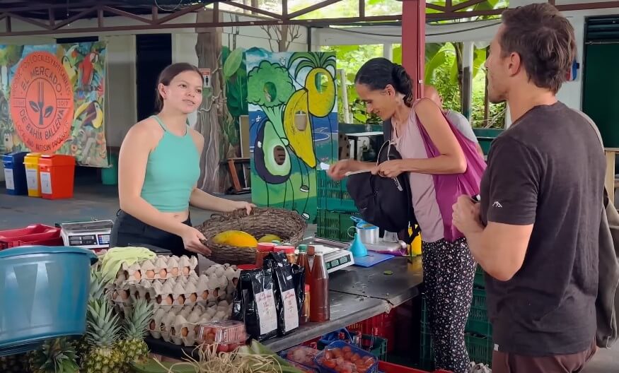 Fresh produce and friendly faces fill the vibrant market stall