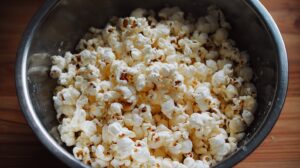 Large metal bowl filled with plain, freshly popped popcorn