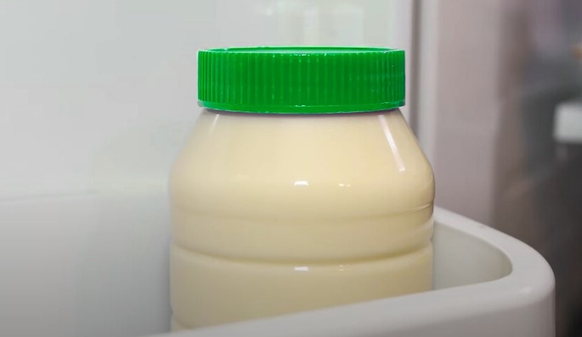 Bottle of homemade mayonnaise in a refrigerator