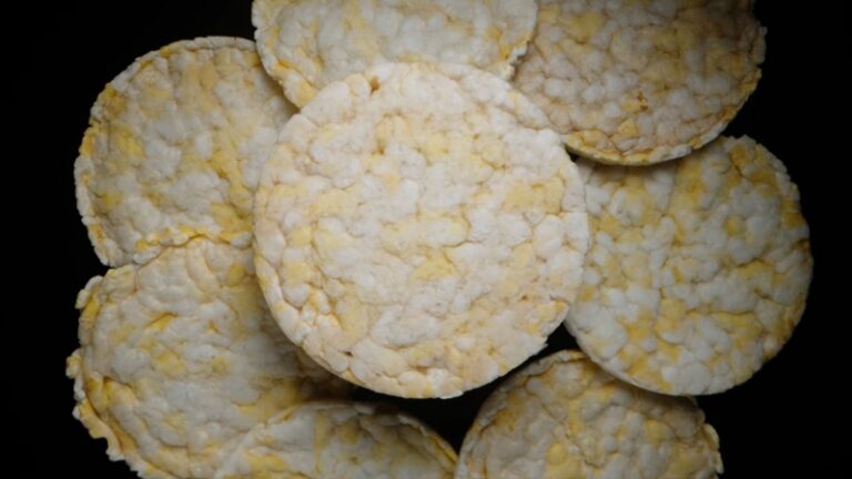 Plain rice cakes stacked together on a dark background