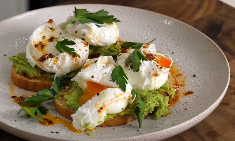 Poached eggs with avocado ricotta in a plate