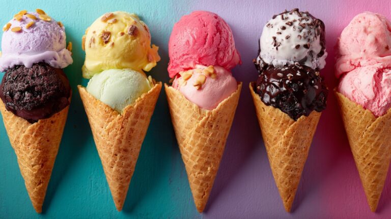 Five colorful ice cream cones with different flavors and toppings arranged in a row against a pastel background