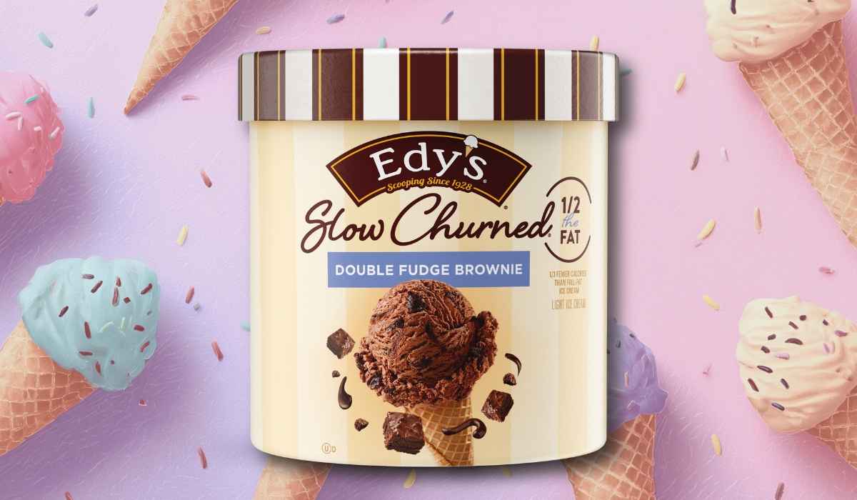 Edy’s Slow Churned Double Fudge Brownie ice cream pint with brown-striped lid on a pastel background decorated with ice cream cones and sprinkles