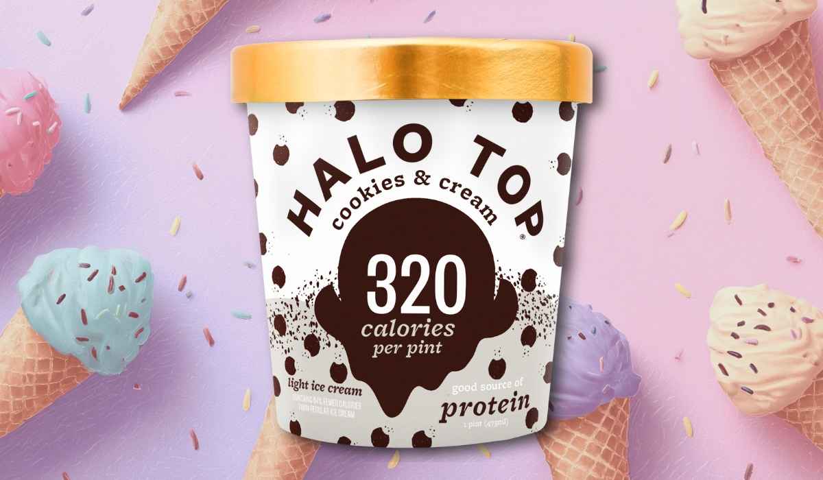 Halo Top Cookies & Cream ice cream pint with gold lid on a pastel background decorated with ice cream cones and sprinkles