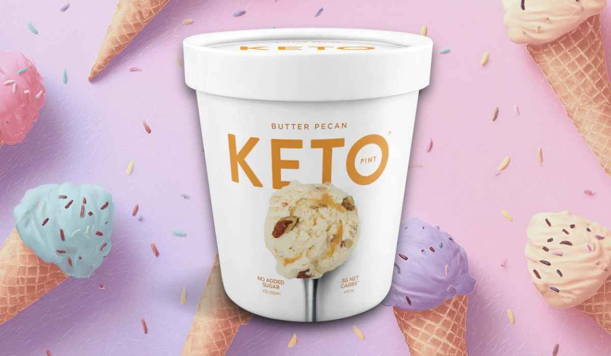 Keto Pint Butter Pecan ice cream pint with white packaging on a pastel background decorated with colorful ice cream cones and sprinkles