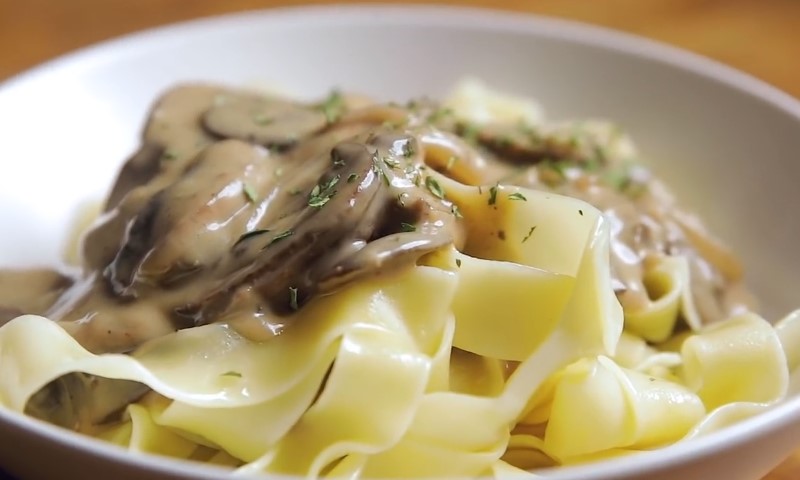 Close up photo of Beef Stroganoff and potatoes in a plate