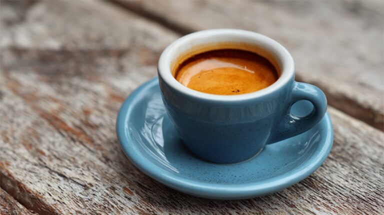 Close-up of a warm espresso in a blue cup and saucer