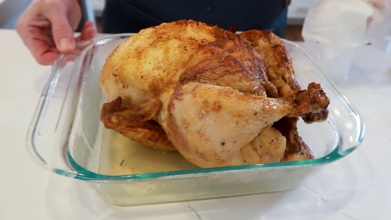 Cooked chicken in a glass dish ready to reheat meat leftovers without drying out