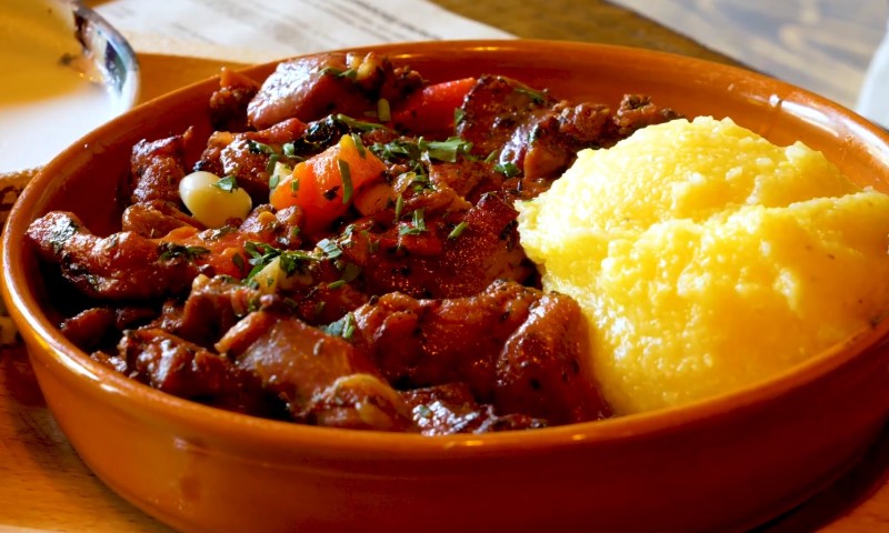 A warm dish featuring savory beef stew with diced tomatoes and herbs
