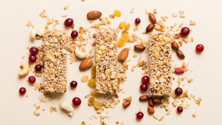 Protein bars with oats, nuts, and dried fruit arranged on a light background
